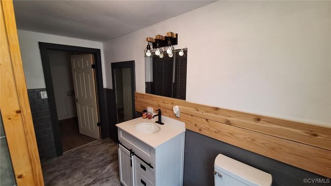 Bathroom featuring vanity, toilet, and wainscoting | Image 24