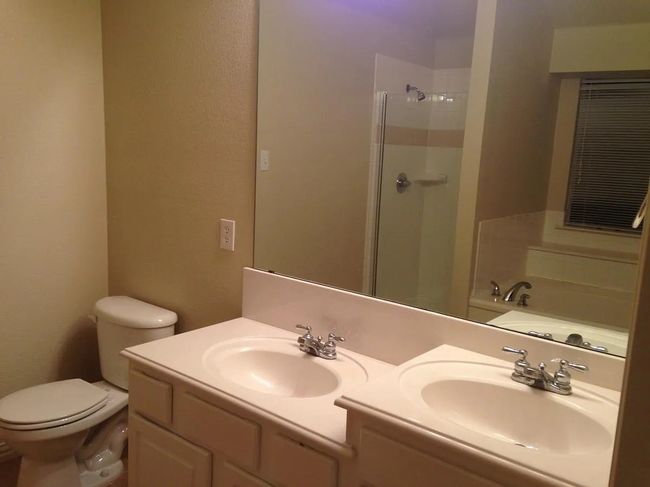 Full bath featuring double vanity, a shower, and a garden tub | Image 11