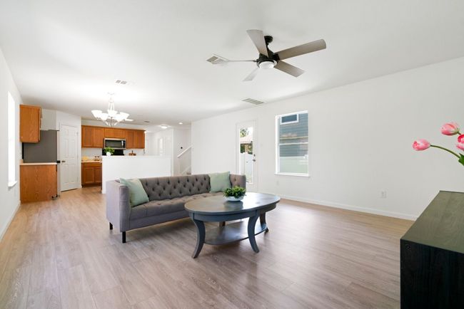 Inside, the main floor offers an open and cohesive layout with wood-look flooring throughout. | Image 4