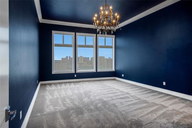 The primary bedroom with a gorgeous chandelier also has an abundance of natural light and you also get the amazing view! | Image 17
