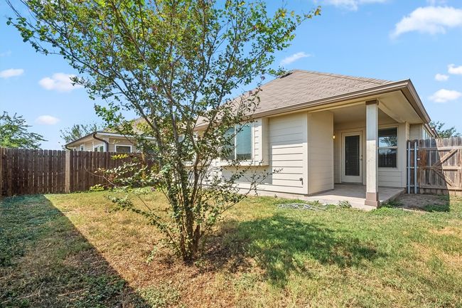 Back yard with a covered patio area. | Image 29