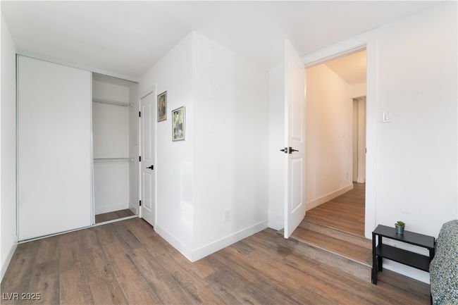 Hallway featuring baseboards and wood finished floors | Image 29