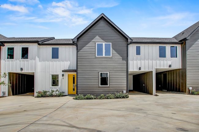 View of front of home with board and batten siding, concrete driveway, and a shingled roof | Image 27
