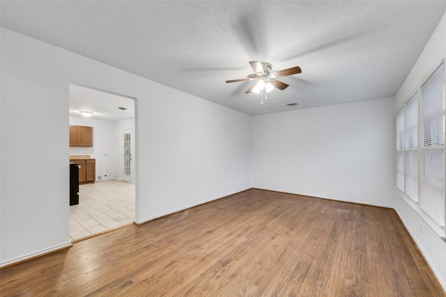 Unfurnished room with ceiling fan, baseboards, and light wood-type flooring | Image 4