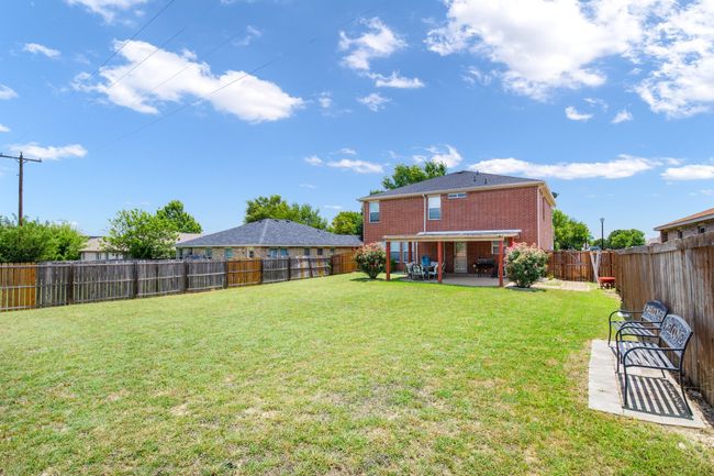 Fenced backyard featuring a patio area | Image 19