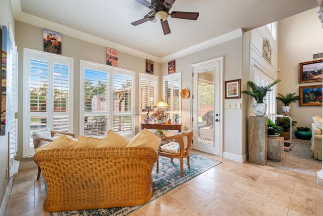 Living area with ceiling fan and ornamental molding | Image 25