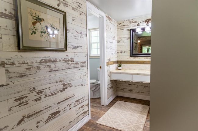Wall facing door to the den and primary vanity beyond. Door on the right is to den and partially open for clarity. | Image 32