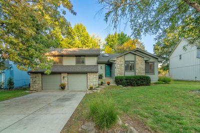 View of front of property with a front lawn and a garage | Image 1