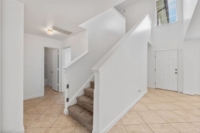 Staircase with tile patterned floors and baseboards | Image 18