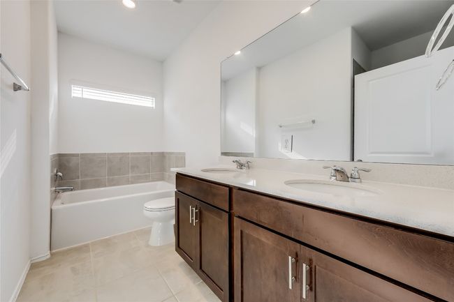 Bathroom featuring double vanity, a garden tub, and tile patterned flooring | Image 21