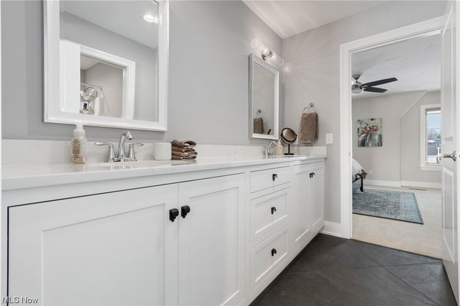 Bathroom with tile floors, double sink vanity, and ceiling fan | Image 26