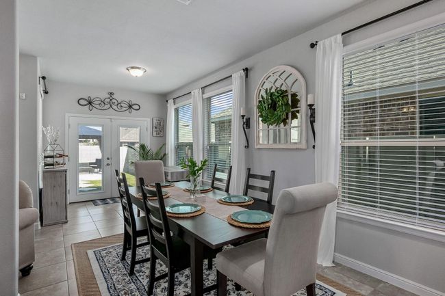 Dining space featuring french doors, light tile patterned floors, and baseboards | Image 7