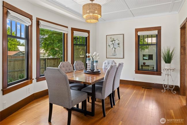 The dining area exudes timeless elegance, perfectly complementing the home’s period details. | Image 8