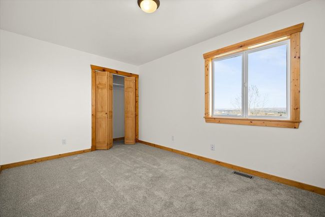 Unfurnished bedroom featuring light carpet, baseboards, and a closet | Image 10