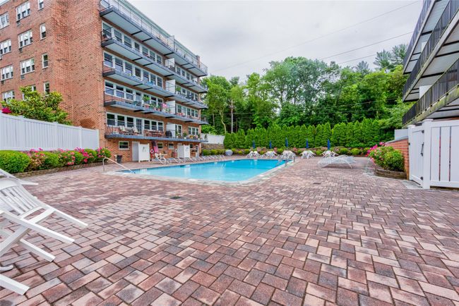 Pool with a patio area and fence | Image 25