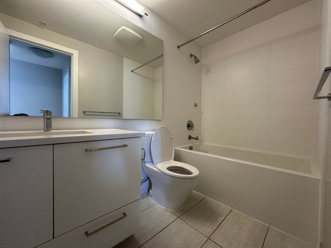 Bathroom with vanity, shower / bathtub combination, toilet, and tile patterned flooring | Image 23