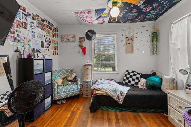 Bedroom featuring hardwood / wood-style flooring and crown molding | Image 30