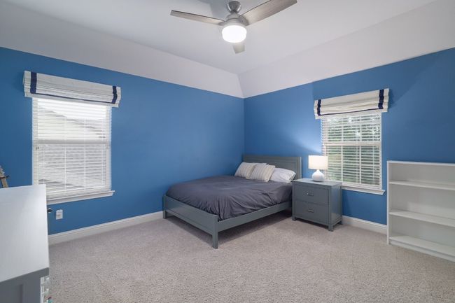 Carpeted bedroom with baseboards and a ceiling fan | Image 26