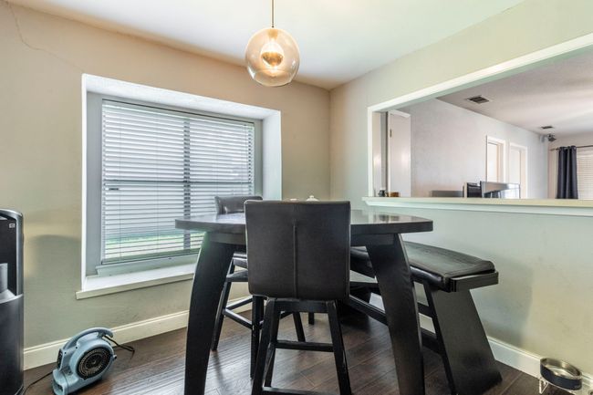 Dining room featuring baseboards, plenty of natural light, and dark wood-type flooring | Image 9