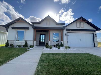 Craftsman-style house featuring a garage, a front yard, and a porch | Image 2