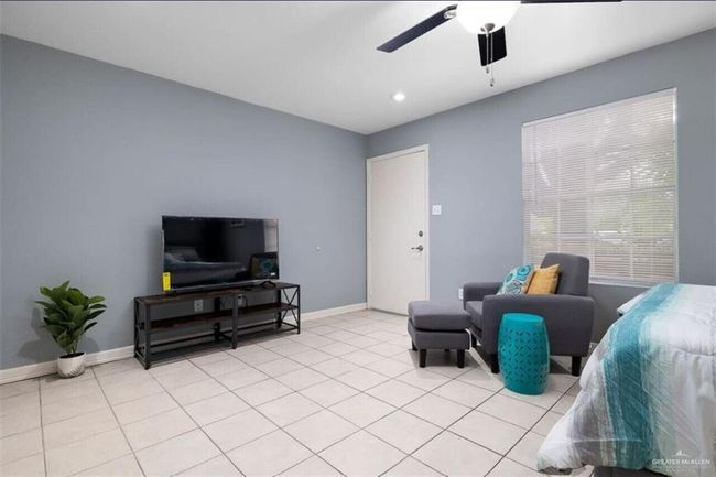 Living area featuring a ceiling fan, light tile patterned floors, and recessed lighting | Image 4