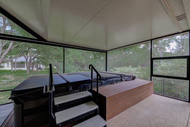 Sunroom / solarium featuring a swim/spa | Image 36