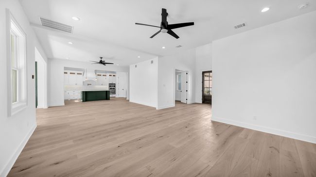 Unfurnished living room featuring visible vents, recessed lighting, light wood-type flooring, and baseboards | Image 9