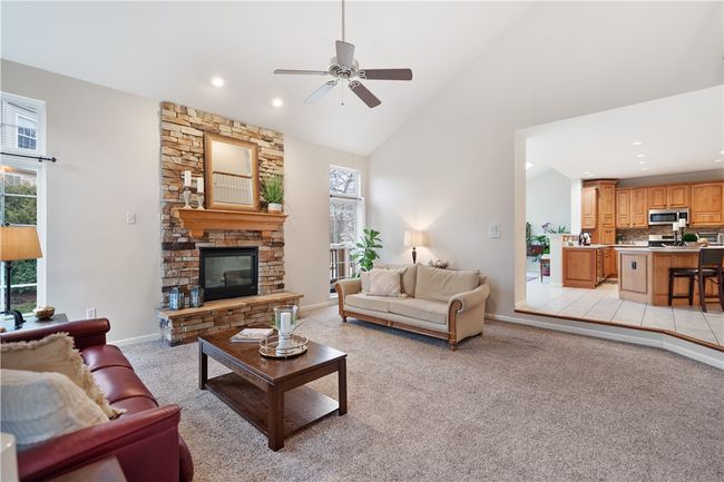 Floor to ceiling stacked stone gas fireplace is the focal point of the great room. | Image 11