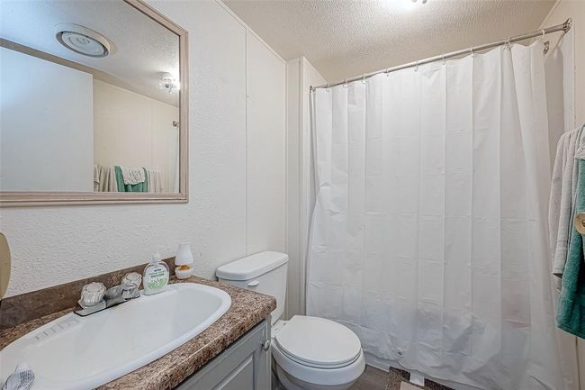 The bathroom features a clean, functional design, a spacious shower or bathtub. | Image 13