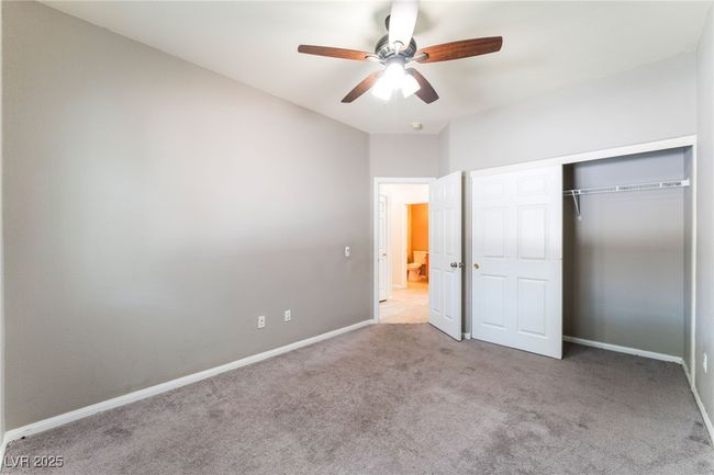 Unfurnished bedroom with carpet, baseboards, a closet, and ceiling fan | Image 38