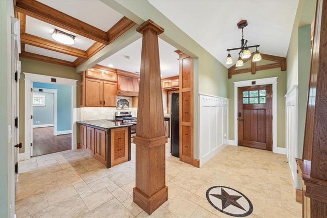 THESE CUSTOM PILLARS FRAME YOUR ENTRY INTO THE HOME, GRACEFULLY INTRODUCING THE OPEN FLOOR PLAN. GORGEOUS CUSTOM-LAID TILE GIVES A REFINED SETTING. | Image 7