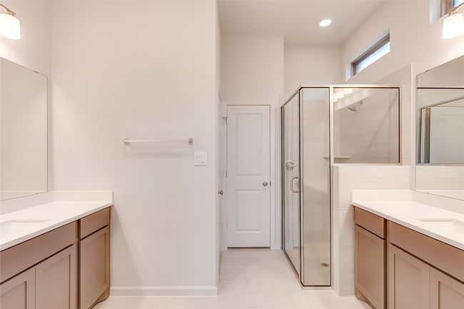 Full bathroom with two vanities, a shower stall, and baseboards | Image 19