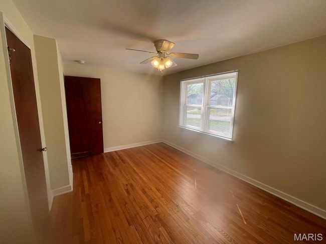 Unfurnished room with baseboards, a ceiling fan, and wood finished floors | Image 19