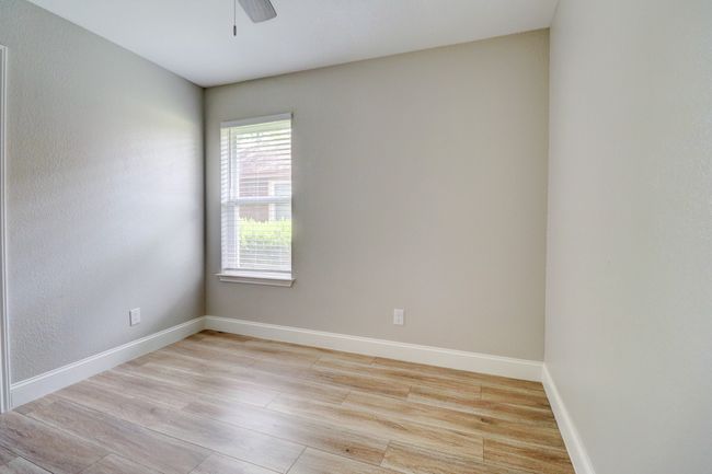 Spare room featuring ceiling fan and light wood finished floors | Image 19