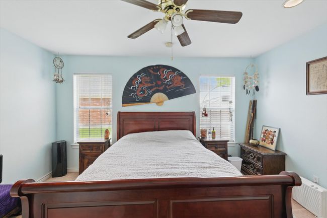 Bedroom with ceiling fan, light carpet, and baseboards | Image 20