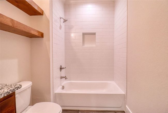 Full bathroom with vanity, toilet, and tiled shower / bath | Image 18