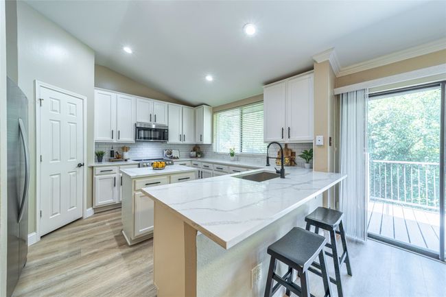 Peninsula area in the kitchen open to the patio | Image 7