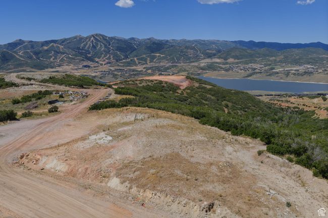 View of mountain background with a large body of water | Image 8
