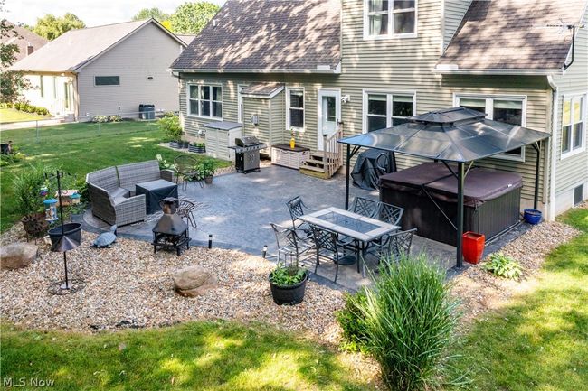 Rear view of house featuring outdoor lounge area, a patio, and a yard | Image 49