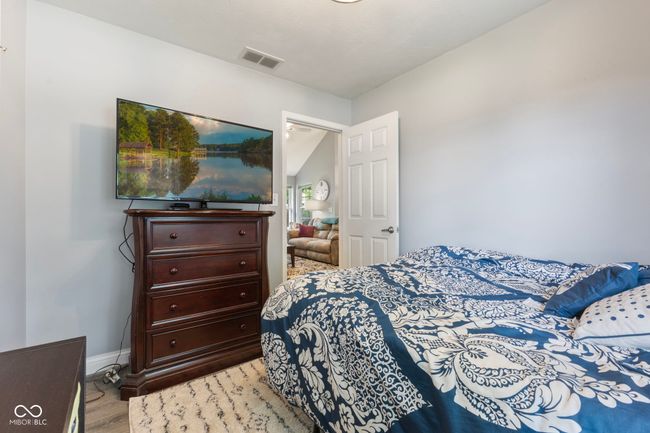 bedroom featuring light wood-style flooring and baseboards | Image 15