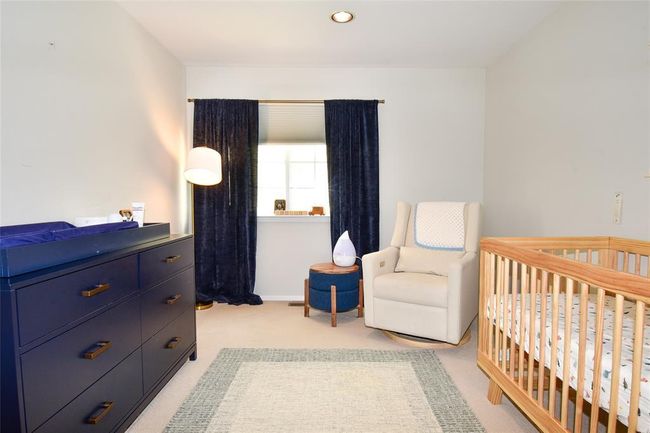 Bedroom featuring light colored carpet, a crib, and recessed lighting | Image 12