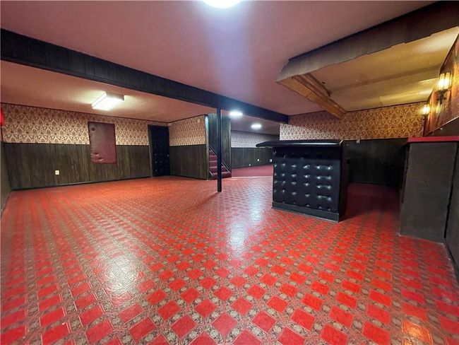 Finished below grade area featuring a community bar, wallpapered walls, and wainscoting | Image 24