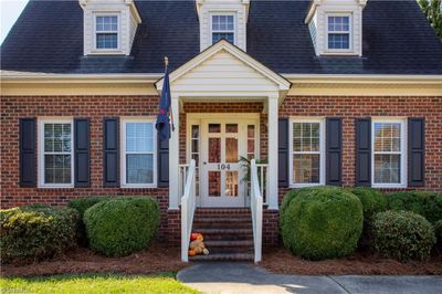 Such a welcoming feel as you approach the front door. A covered stoop adds such a warm touch and provides the perfect place for a potted plant as well as protection from the elements. | Image 3