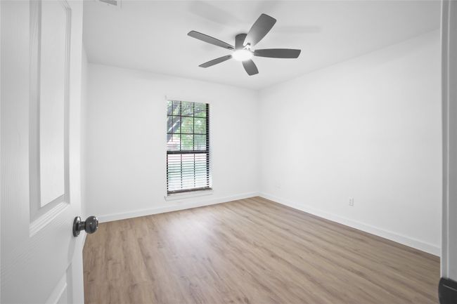 Spare room featuring wood finished floors and a ceiling fan | Image 16