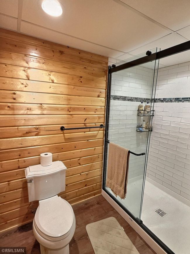 Lower level bathroom with fantastic design elements throughout including wood accents and glass shower. | Image 27