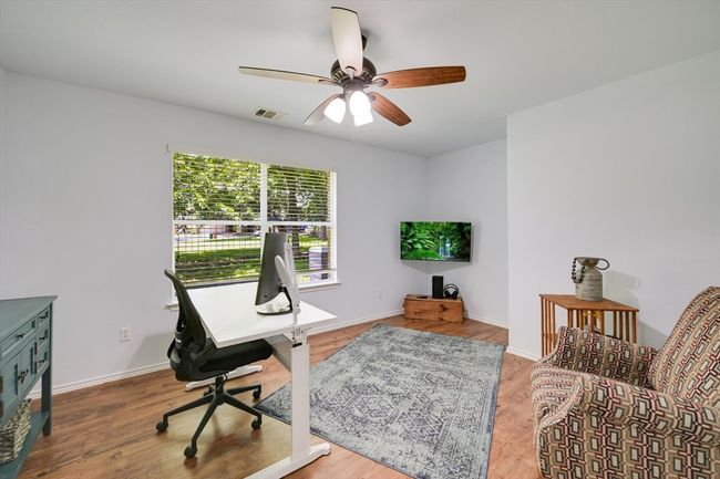 Office area with ceiling fan and wood finished floors | Image 5