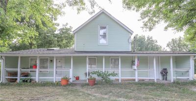 View of front of house with a porch and a front lawn | Image 1