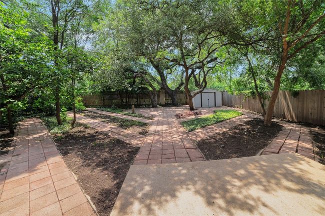 Fenced backyard with a patio | Image 32