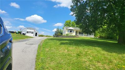 View of yard with a garage and an outdoor structure | Image 3