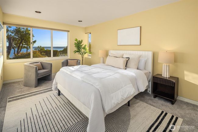 This bedroom enjoys privacy + garden/water views. | Image 27